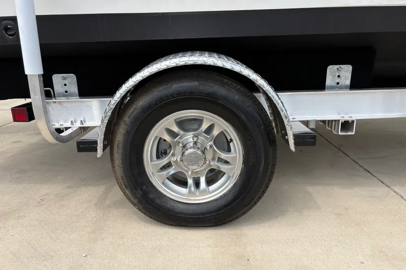 Slide: The Image of Trailer wheel of 2022 Hurricane SunDeck Sport 201 OB boat on concrete surface. - 36