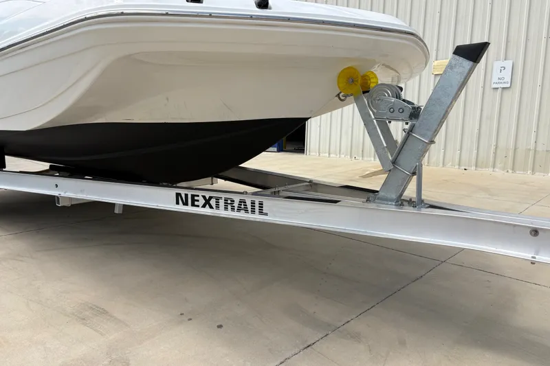 Slide: The Image of 2022 Hurricane SunDeck Sport 201 OB boat on Nextrail trailer, parked outside a building. - 35