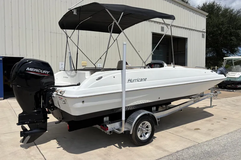 Slide: The Image of 2022 Hurricane SunDeck Sport 201 OB boat with Mercury engine on trailer. - 2