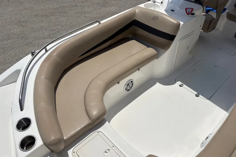 Slide: The Image of 2022 Hurricane SunDeck Sport 201 OB boat interior with beige seating and cup holders. - 22