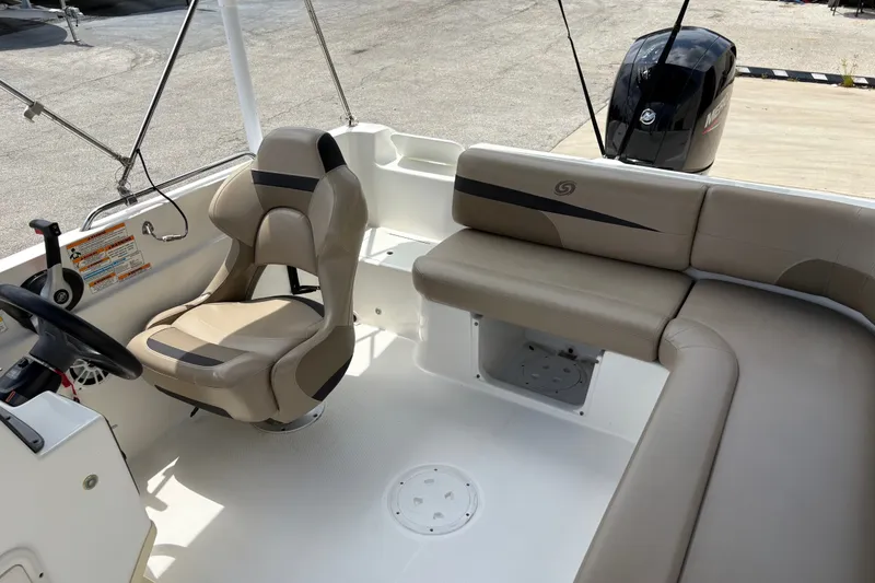 Slide: The Image of 2022 Hurricane SunDeck Sport 201 OB boat interior with seating and steering console. - 26