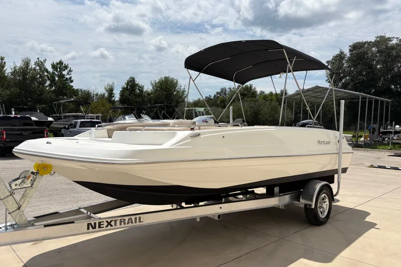 Slide: The Image of 2022 Hurricane SunDeck Sport 201 OB boat on trailer, parked outdoors. - 4
