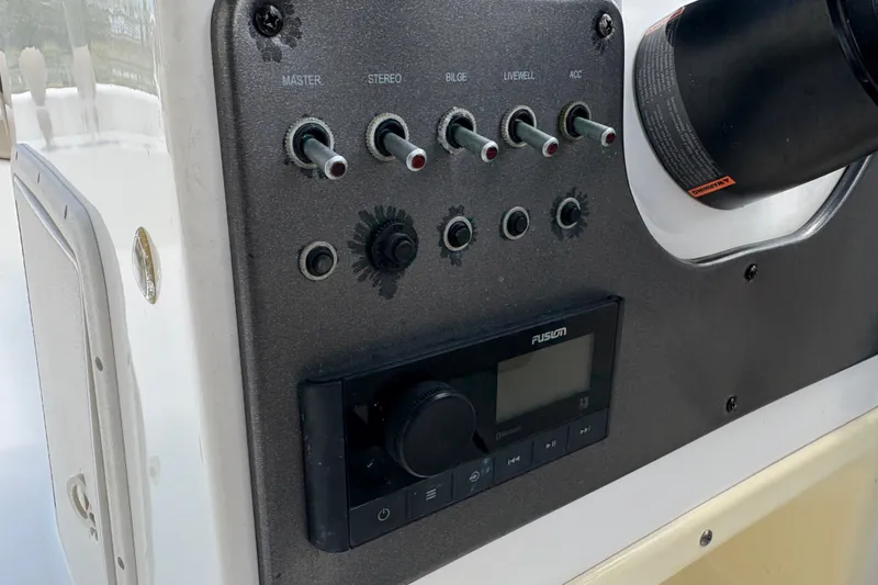 Slide: The Image of Control panel of 2022 Hurricane SunDeck Sport 201 OB boat with switches and stereo system. - 30