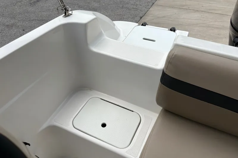 Slide: The Image of 2022 Hurricane SunDeck Sport 201 OB boat interior with beige seating and storage compartment. - 32