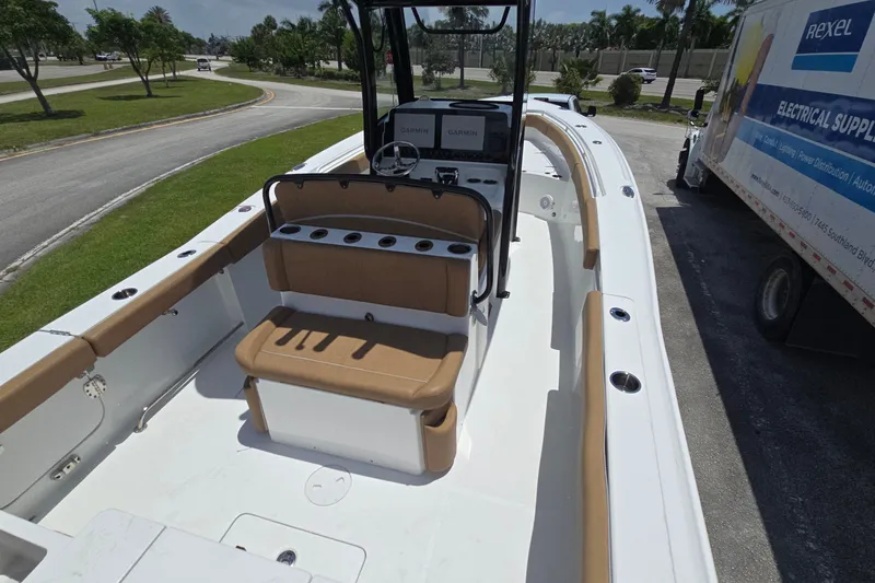 Slide: The Image of 2023 Sea Hunt Ultra 275SE boat interior with tan seating and Garmin navigation system. - 20
