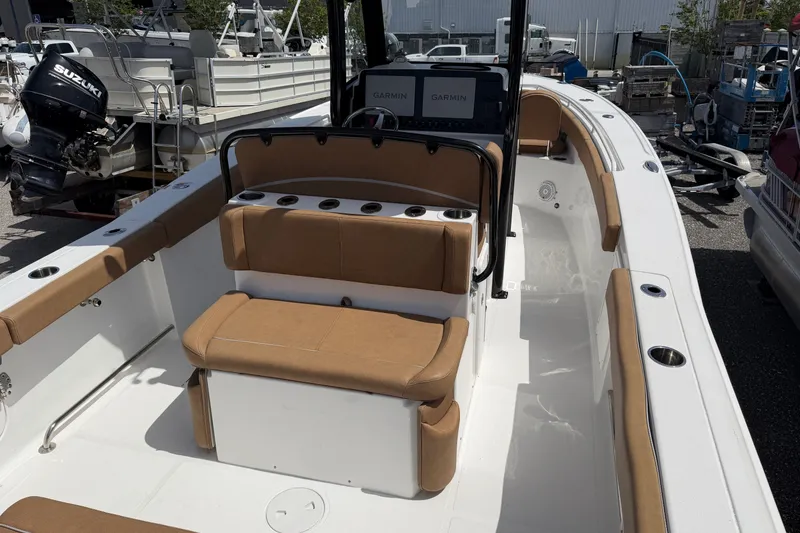 Slide: The Image of 2023 Sea Hunt Ultra 275SE boat interior with tan seating and Garmin electronics. - 19