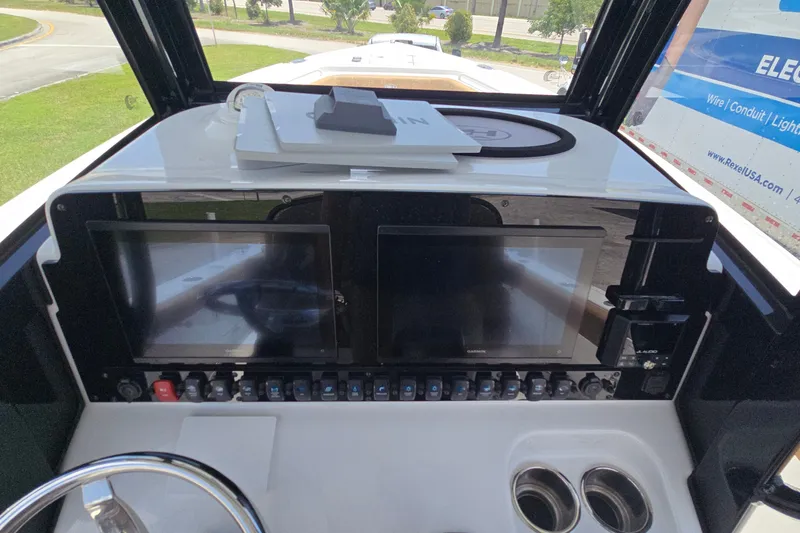 Slide: The Image of Dashboard of 2023 Sea Hunt Ultra 275SE boat with dual screens and controls. - 25