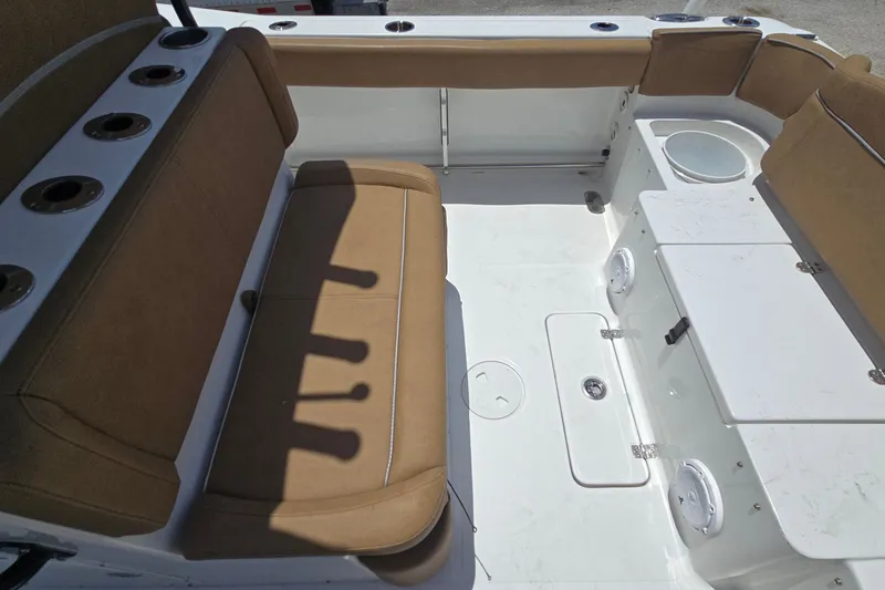 Slide: The Image of Interior of 2023 Sea Hunt Ultra 275SE boat with tan seating and rod holders. - 23