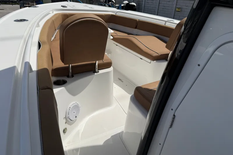 Slide: The Image of 2023 Sea Hunt Ultra 275SE boat interior with tan seating and white deck. - 17