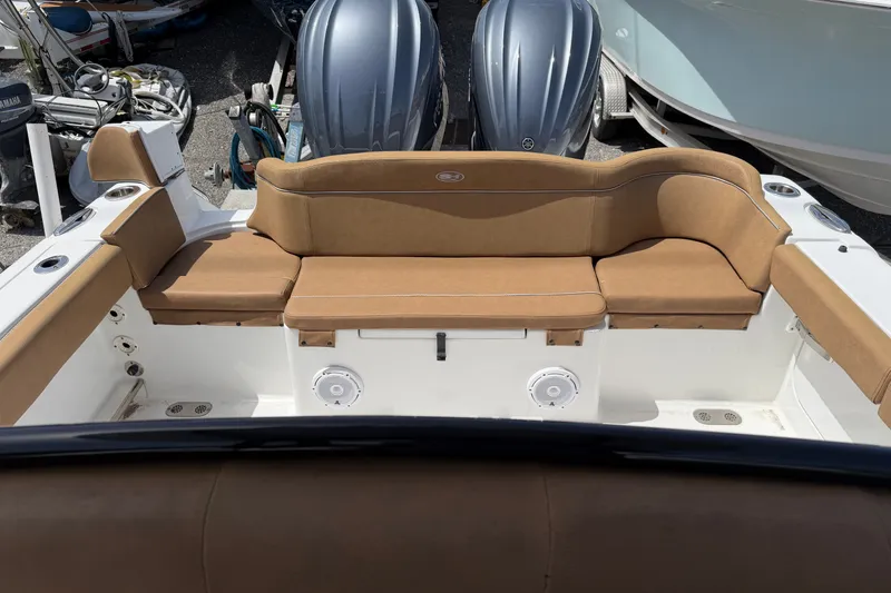 Slide: The Image of 2023 Sea Hunt Ultra 275SE boat interior with tan seating and dual engines. - 16
