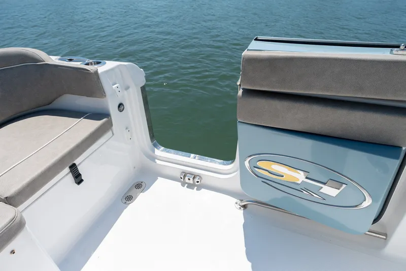 Slide: The Image of 2024 Sea Hunt Ultra 265SE boat interior with seating and water view. - 29