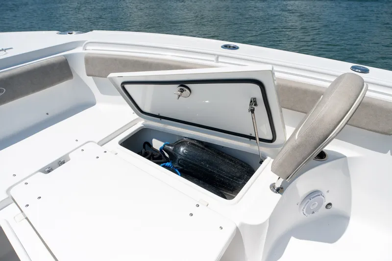 Slide: The Image of 2024 Sea Hunt Ultra 265SE boat storage compartment open on deck. - 13