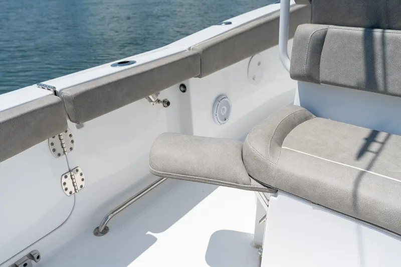Slide: The Image of 2024 Sea Hunt Ultra 265SE boat interior with cushioned seating and stainless steel fixtures. - 31
