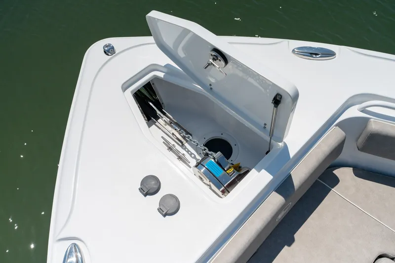 Slide: The Image of 2024 Sea Hunt Ultra 265SE boat anchor compartment open on deck. - 10