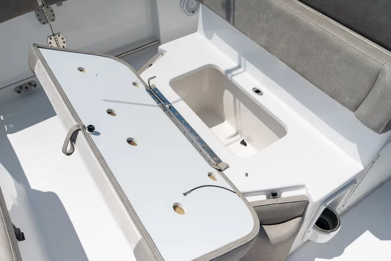 Slide: The Image of 2024 Sea Hunt Ultra 265SE boat seating with storage compartment open. - 33