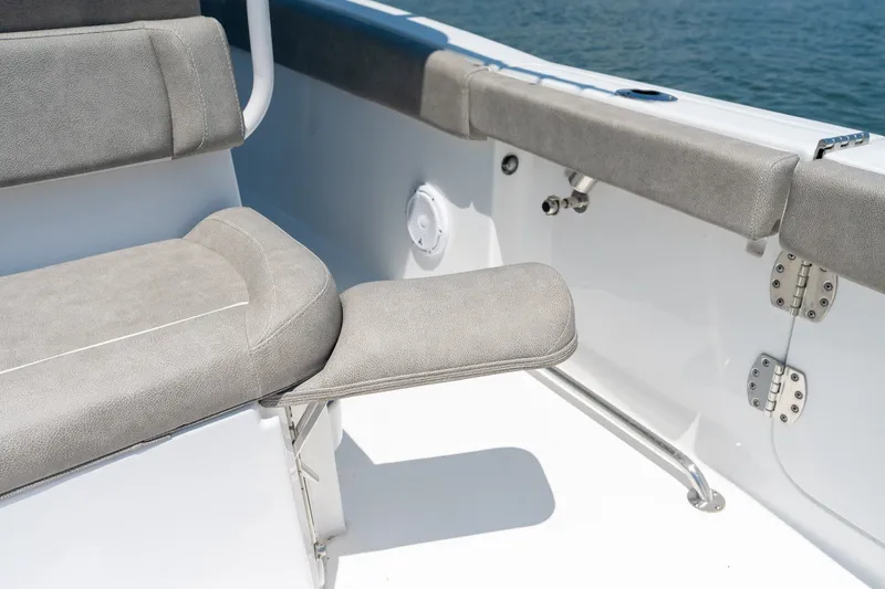 Slide: The Image of 2024 Sea Hunt Ultra 265SE boat seating detail with gray upholstery and stainless steel fixtures. - 32