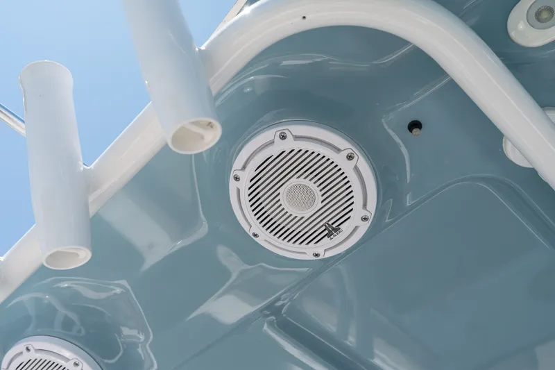 Slide: The Image of 2024 Sea Hunt Ultra 265SE boat speaker and rod holders against blue sky. - 22