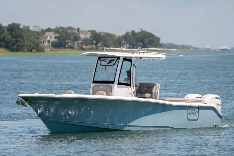 The Image of 2024 Sea Hunt Ultra 265SE boat cruising on a calm lake. - 0