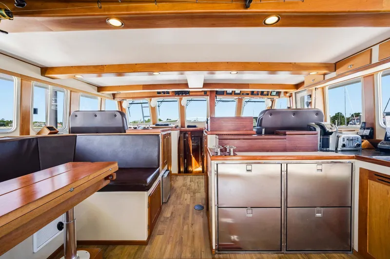 Slide: The Image of Interior of a 2018 Dixon 55 boat, featuring wood accents and modern amenities. - 40