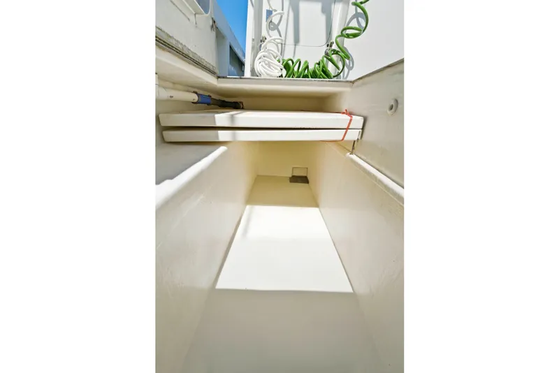 Slide: The Image of Interior storage compartment of 2018 Dixon 55 boat, featuring organized equipment and bright lighting. - 62