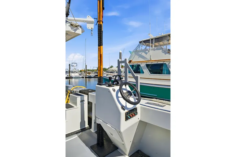 Slide: The Image of Boat steering console on a Dixon 55, 2018 model, docked at a marina. - 32