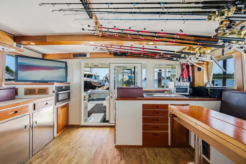 Slide: The Image of Interior of 2018 Dixon 55 boat with fishing rods and modern amenities. - 39