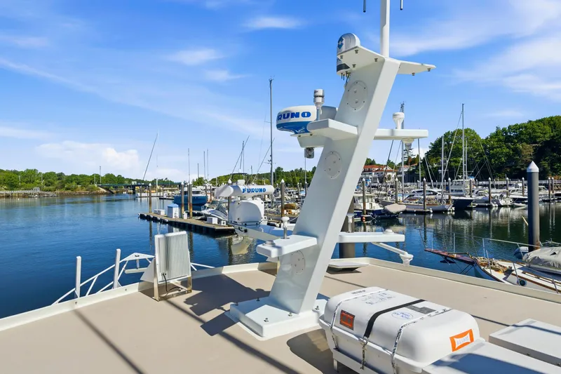 Slide: The Image of Marina view with Dixon 55 boat equipment, featuring radar and life raft, under clear blue sky. - 20