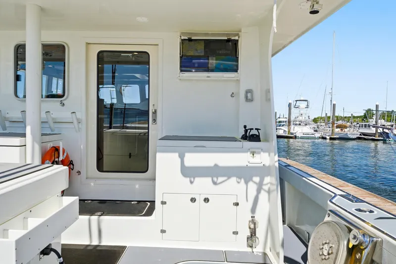 Slide: The Image of Dixon 55 boat interior, 2018 model, docked at marina with clear blue sky. - 23