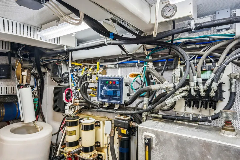Slide: The Image of Engine room of a 2018 Dixon 55, showcasing complex wiring and machinery. - 46