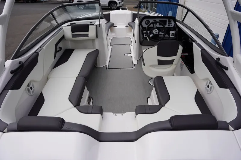 Slide: The Image of 2022 Yamaha Boats AR210 interior with spacious seating and modern dashboard design. - 6
