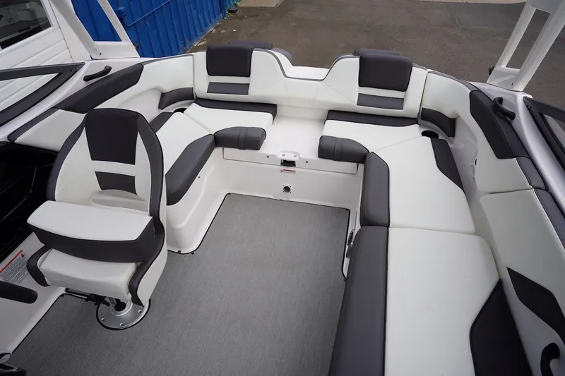 Slide: The Image of 2022 Yamaha Boats AR210 interior with sleek black and white seating arrangement. - 3