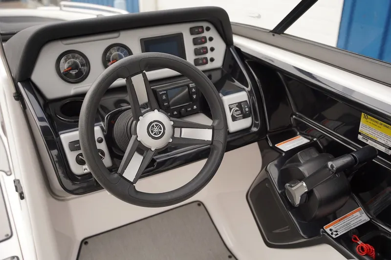 Slide: The Image of 2022 Yamaha AR210 boat dashboard with steering wheel and control panel. - 4