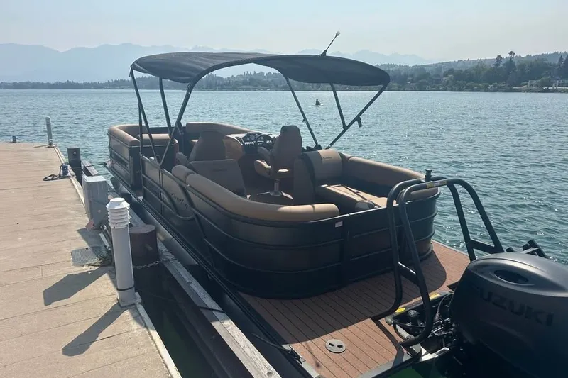 Slide: The Image of 2026 Bentley Pontoons Legacy 243 Navigator docked on a serene lake. - 1