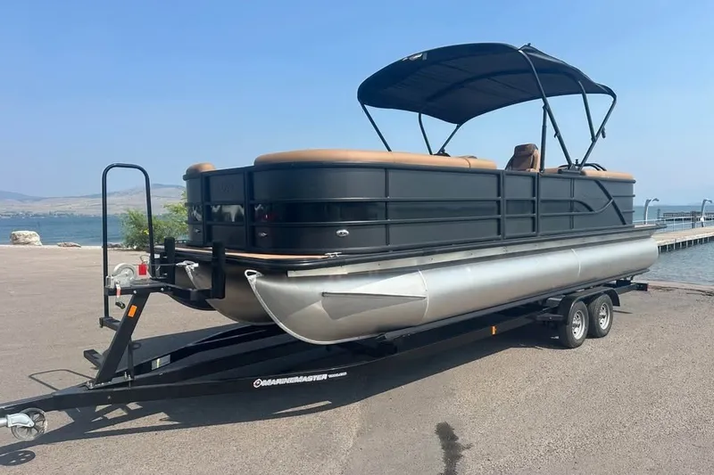 Slide: The Image of 2026 Bentley Pontoons Legacy 243 Navigator on trailer by lakeside dock. - 7