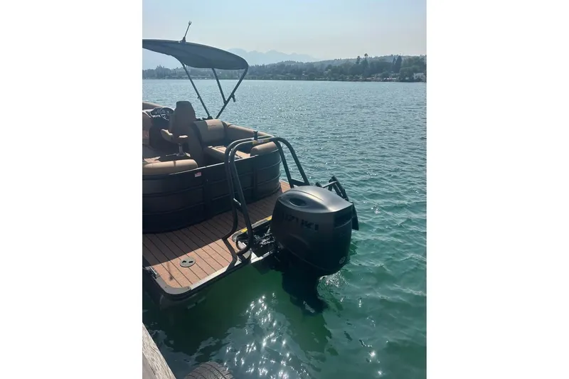 Slide: The Image of 2026 Bentley Pontoons Legacy 243 Navigator on serene lake waters. - 9