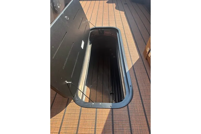Slide: The Image of Open storage compartment on 2026 Bentley Pontoons Legacy 243 Navigator boat deck. - 6