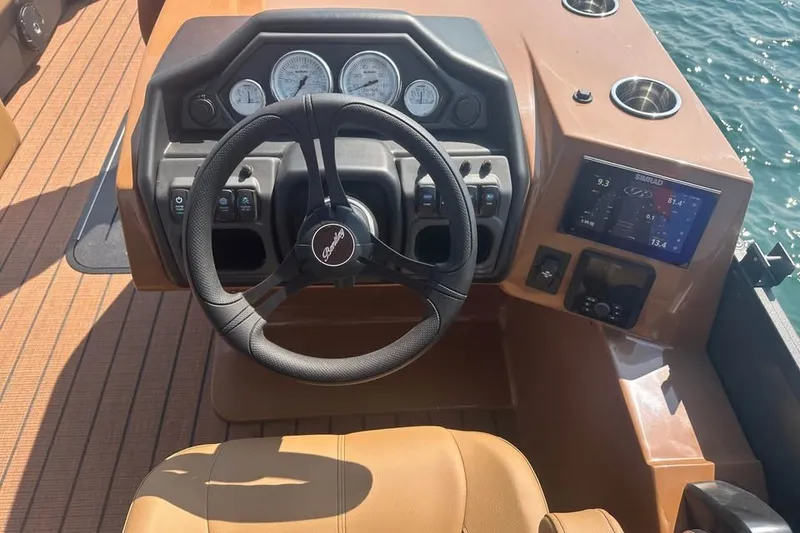Slide: The Image of Steering console of 2026 Bentley Pontoons Legacy 243 Navigator with modern controls and gauges. - 3