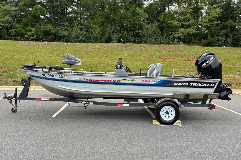 The Image of 1994 Tracker Tournament V-17 bass boat on trailer, parked outdoors. - 0