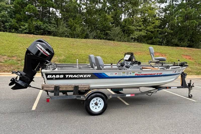 Slide: The Image of 1994 Tracker Tournament V-17 bass boat on trailer, parked outdoors. - 15