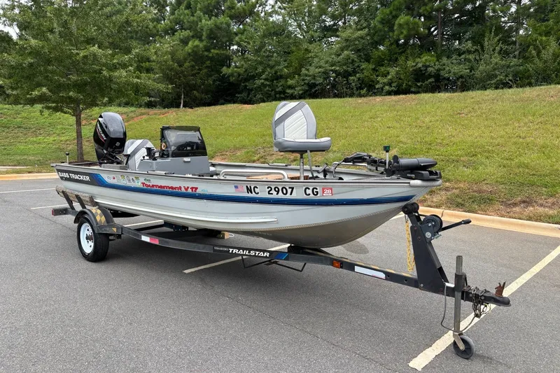 Slide: The Image of 1994 Tracker Tournament V-17 fishing boat on a trailer in a parking lot. - 13