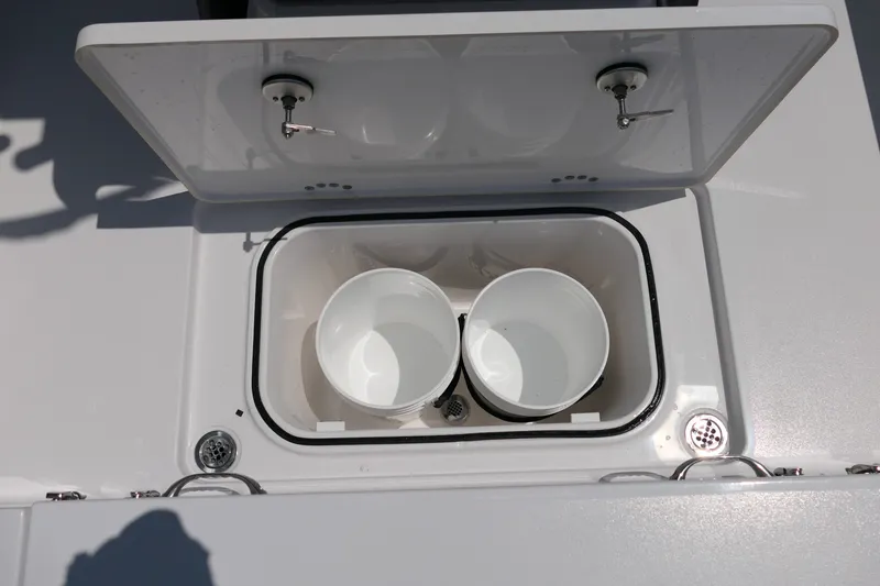 Slide: The Image of Open storage compartment on 2027 Blackfin 262 HB boat with two white buckets inside. - 33