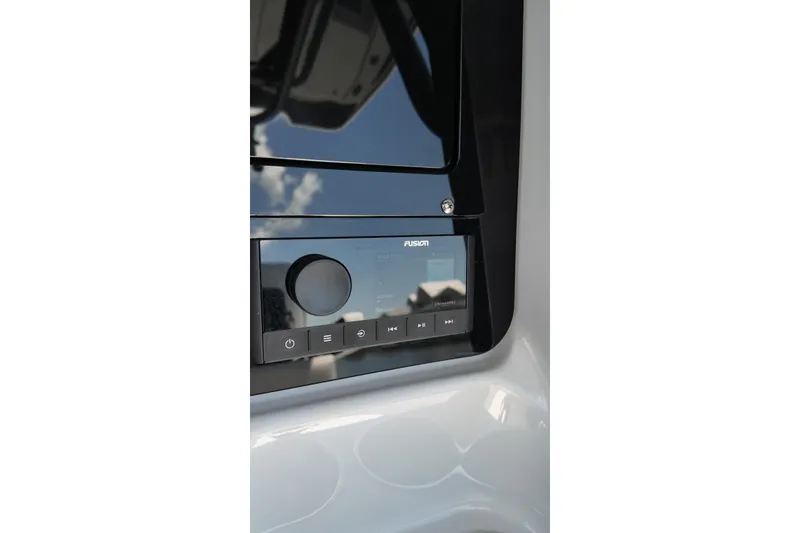 Slide: The Image of Close-up of Fusion audio system on 2027 Blackfin 262 HB boat dashboard. - 15