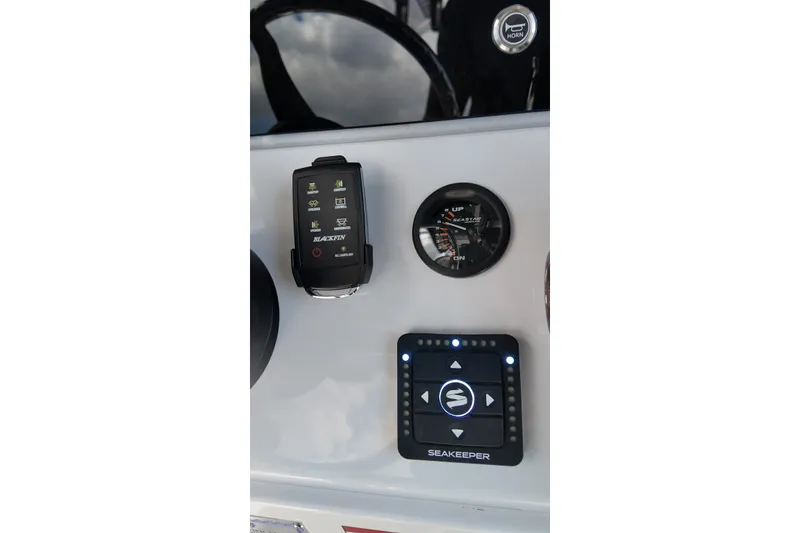 Slide: The Image of Control panel of 2027 Blackfin 262 HB boat featuring Seakeeper and Blackfin systems. - 13