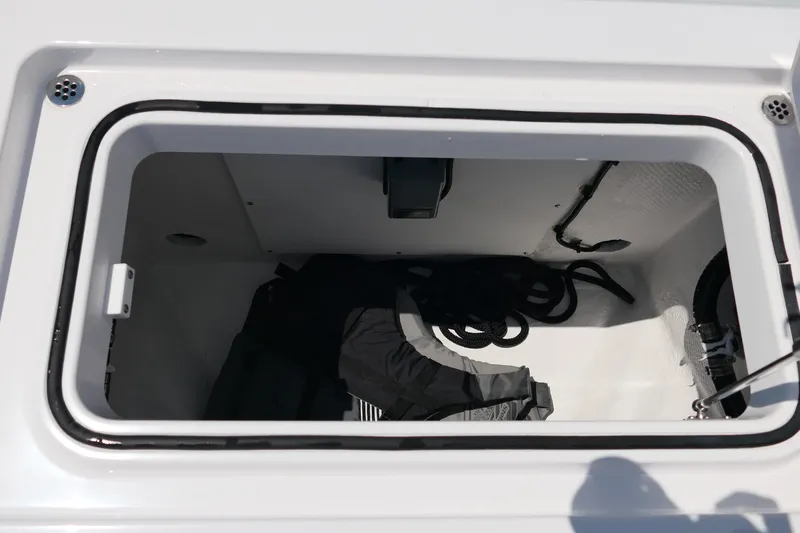 Slide: The Image of Storage compartment of 2027 Blackfin 262 HB boat with coiled rope inside. - 28