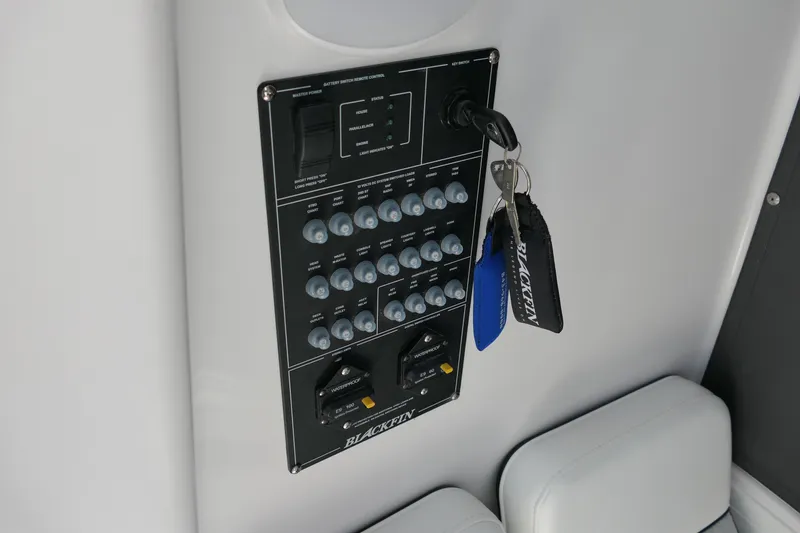 Slide: The Image of Control panel of 2027 Blackfin 262 HB boat with keys attached. - 25