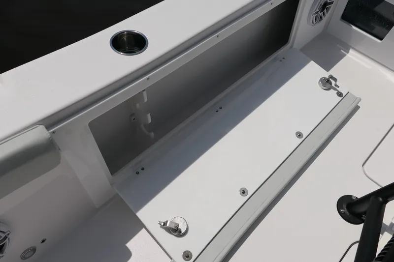 Slide: The Image of 2027 Blackfin 262 HB boat storage compartment with cup holder and speaker. - 32
