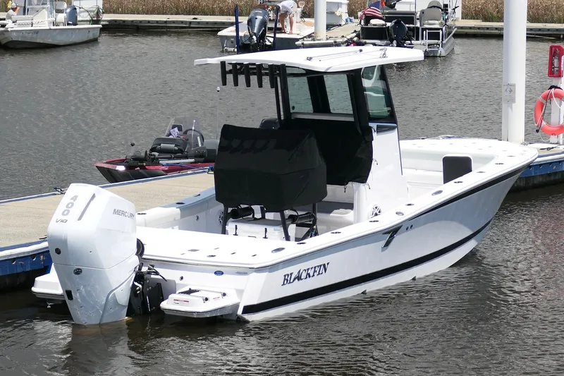 The Image of 2027 Blackfin 262 HB boat docked with Mercury engine, white hull, and sleek design. - 0