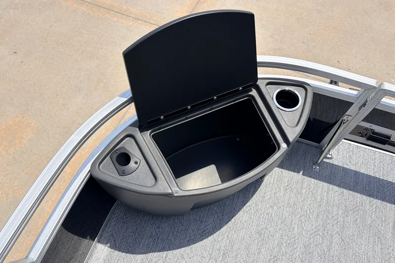 Slide: The Image of 2027 Sun Tracker Bass Buggy 18 DLX boat storage compartment with cup holders. - 15