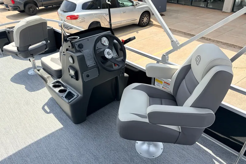 Slide: The Image of 2027 Sun Tracker Bass Buggy 18 DLX boat interior with steering console and seating. - 22