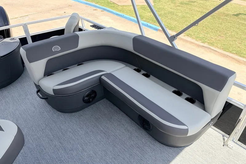 Slide: The Image of 2027 Sun Tracker Bass Buggy 18 DLX pontoon boat with gray seating and cup holders. - 25
